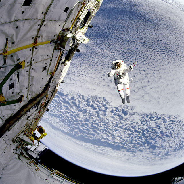 APOD: 2001 October 2 – A Flying Astronaut Over Earth