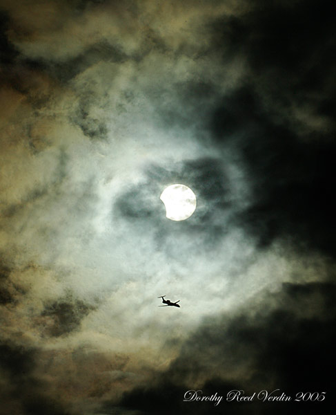APOD: 2005 April 11 – Clouds, Plane, Sun, Eclipse
