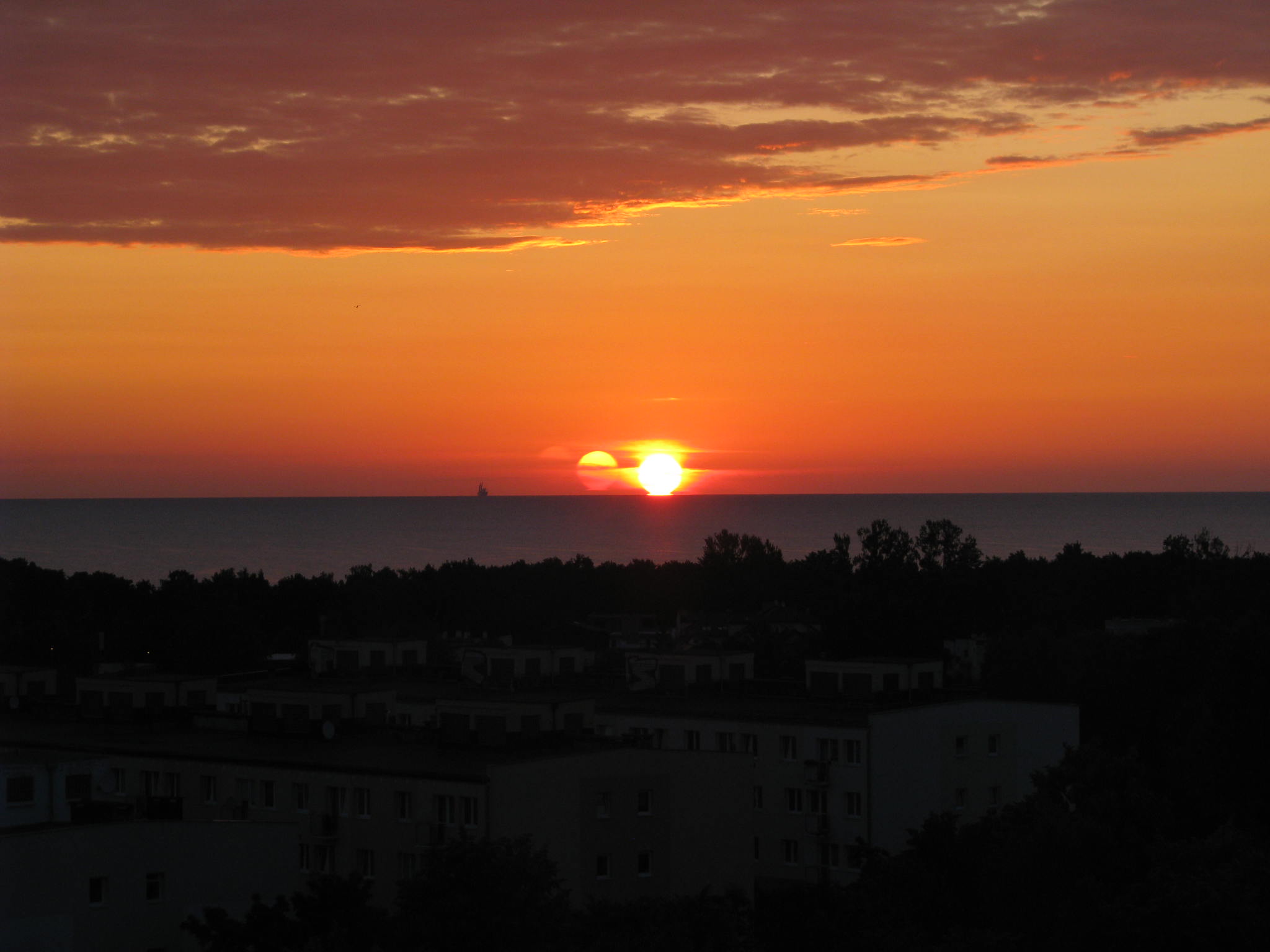 APOD: 2009 August 4 – A Triple Sunrise Over Gdansk Bay