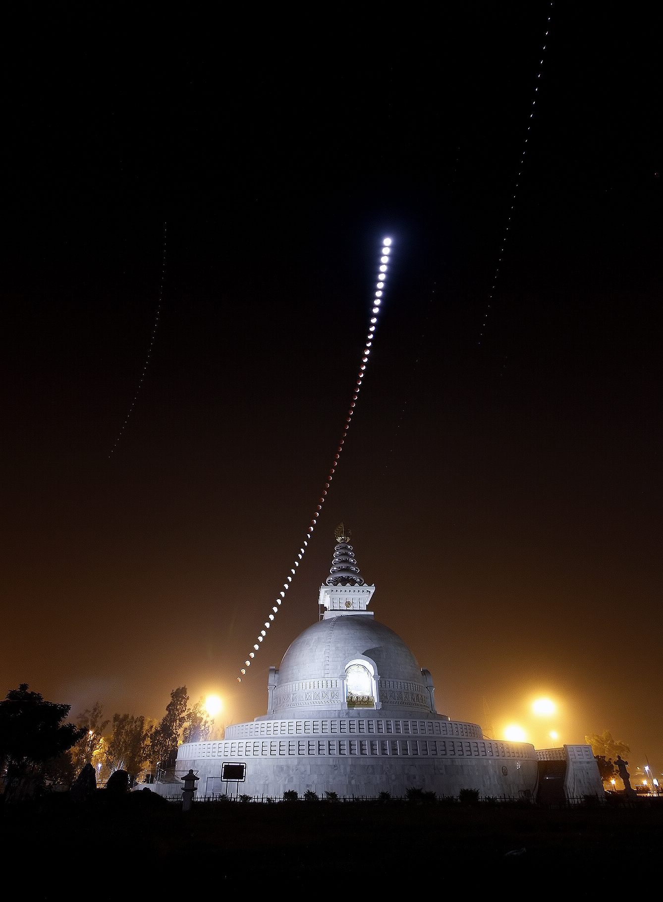 APOD: 2011 December 14 – A Lunar Eclipse Over an Indian Peace Pagoda