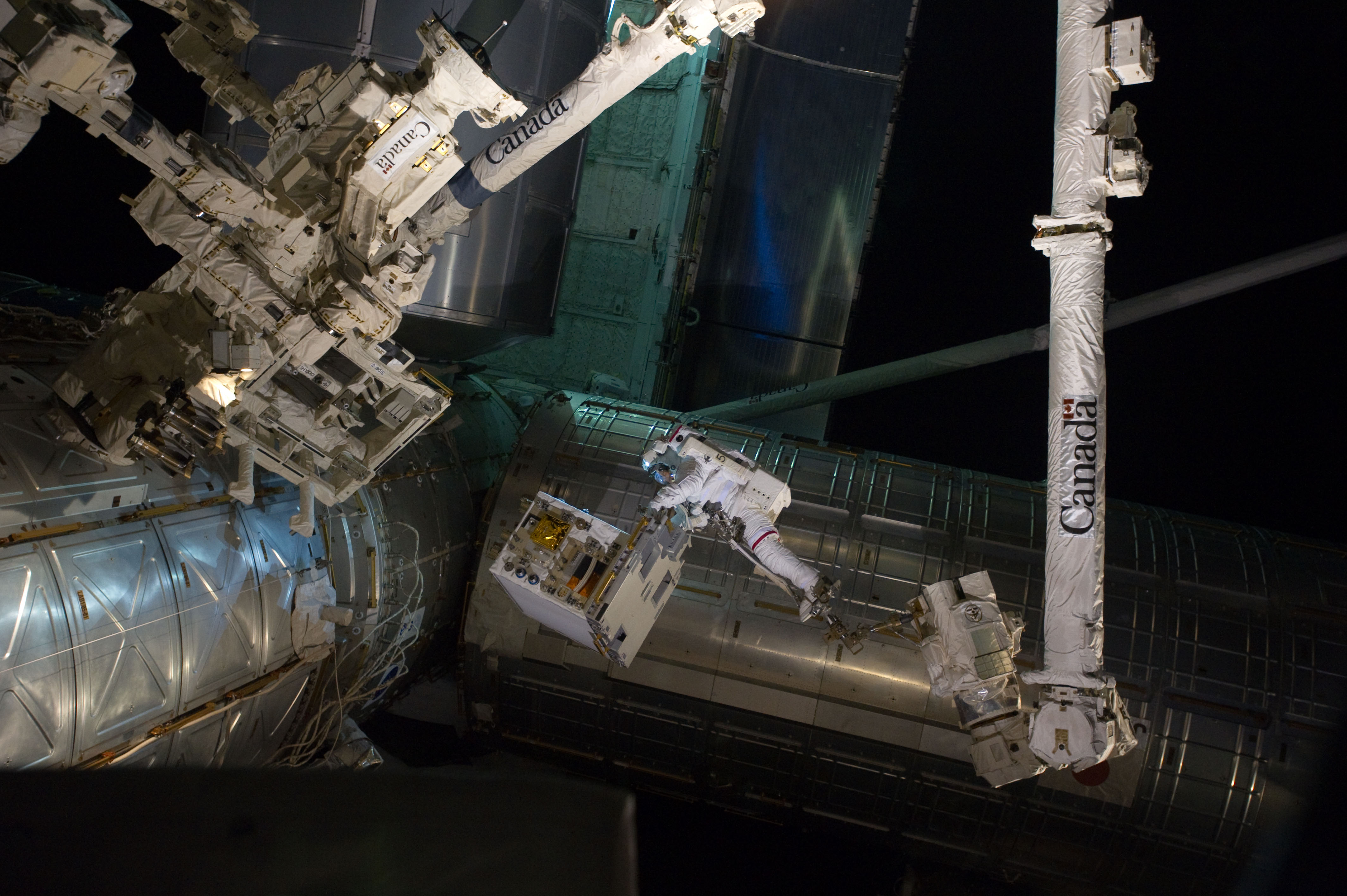 APOD: 2011 July 18 – A Busy Space Walk at the Space Station