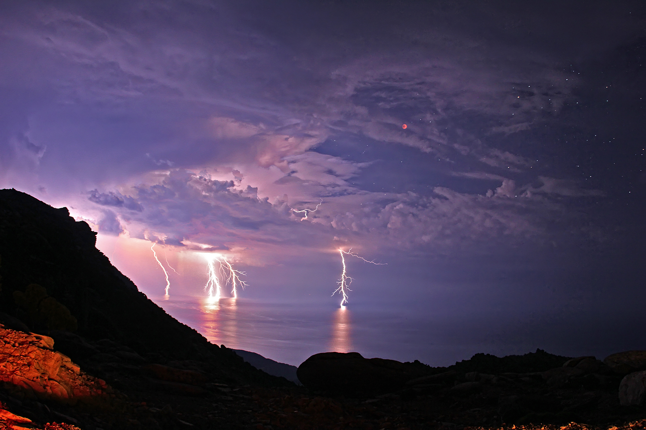APOD: 2011 June 18 – Lightning Eclipse from the Planet of the Goats