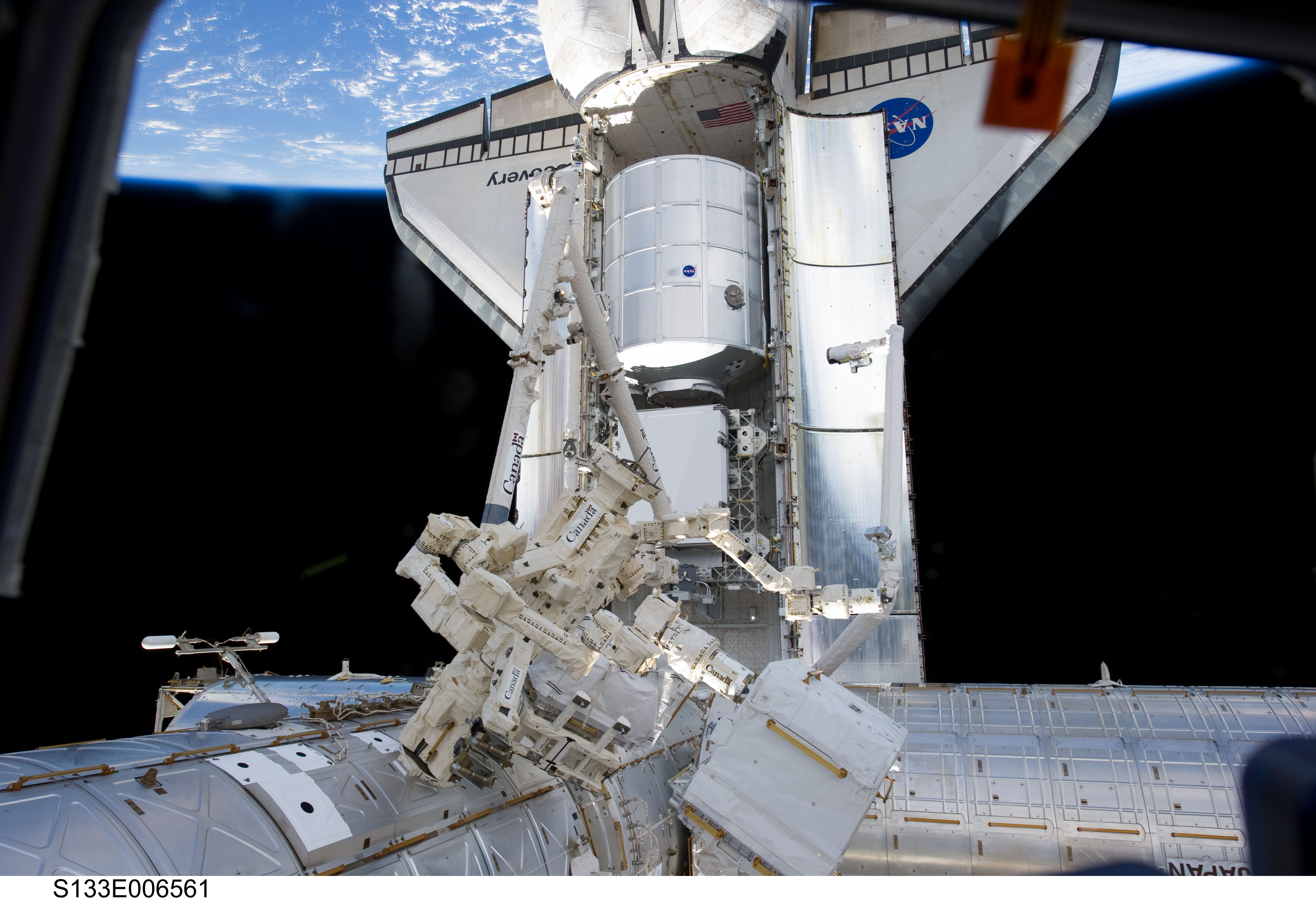APOD: 2011 March 1 – Discovery Visits the Space Station