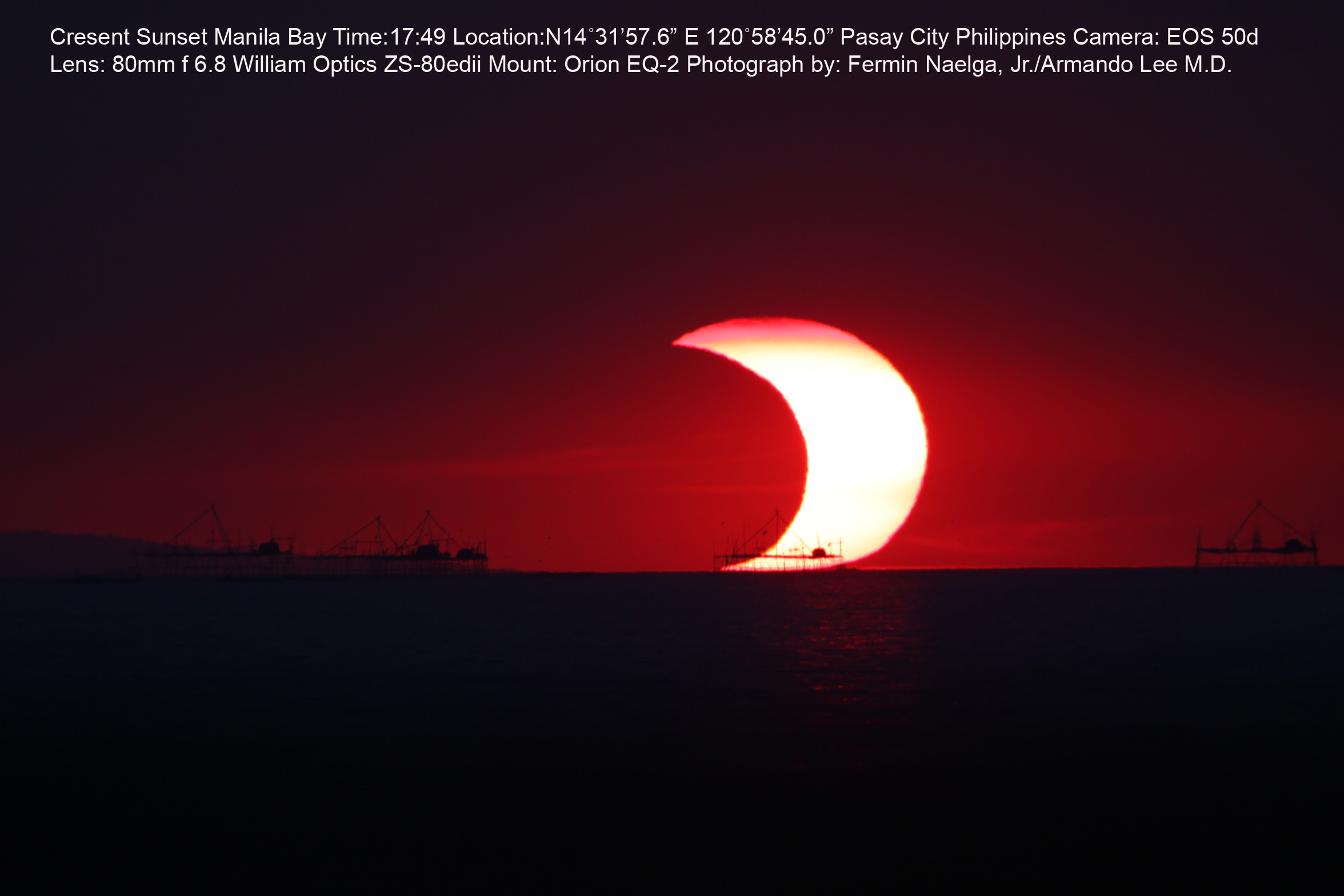 APOD: 2012 May 20 – A Partial Eclipse Over Manila Bay