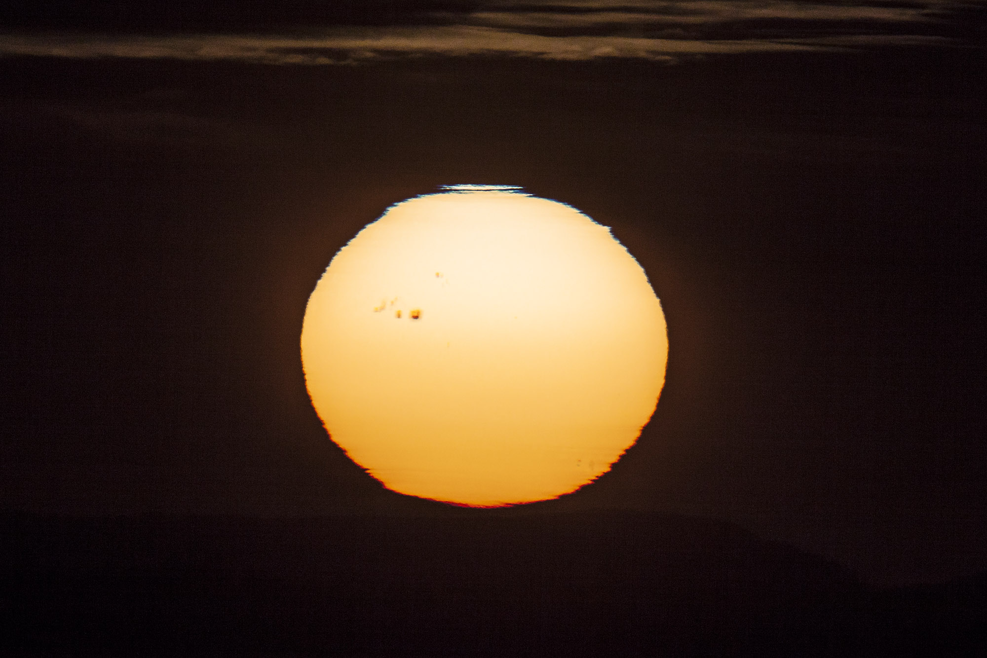 APOD: 2014 January 8 – Sunspot at Sunset