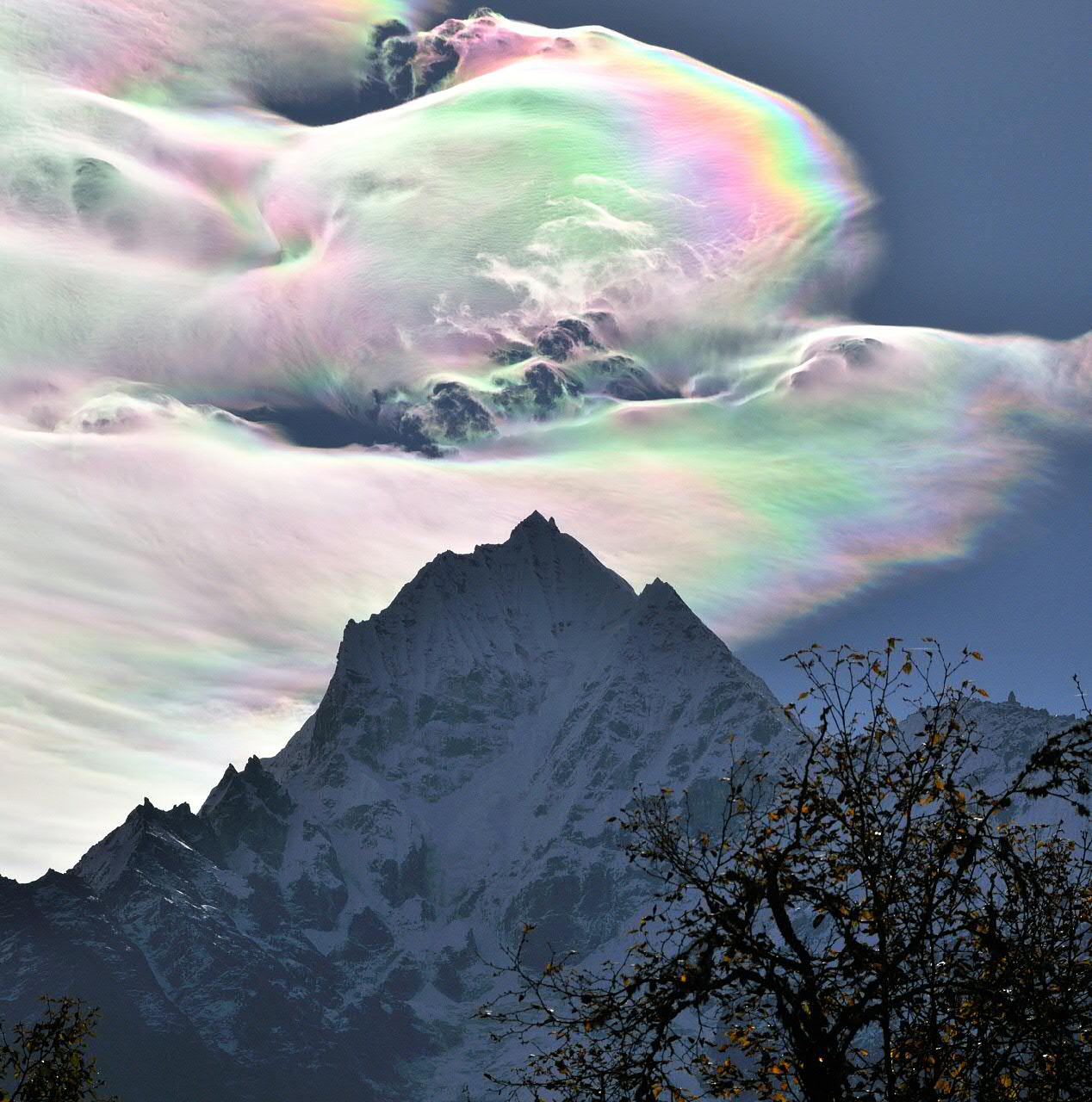 APOD: 2014 July 8 – Iridescent Clouds over Thamserku