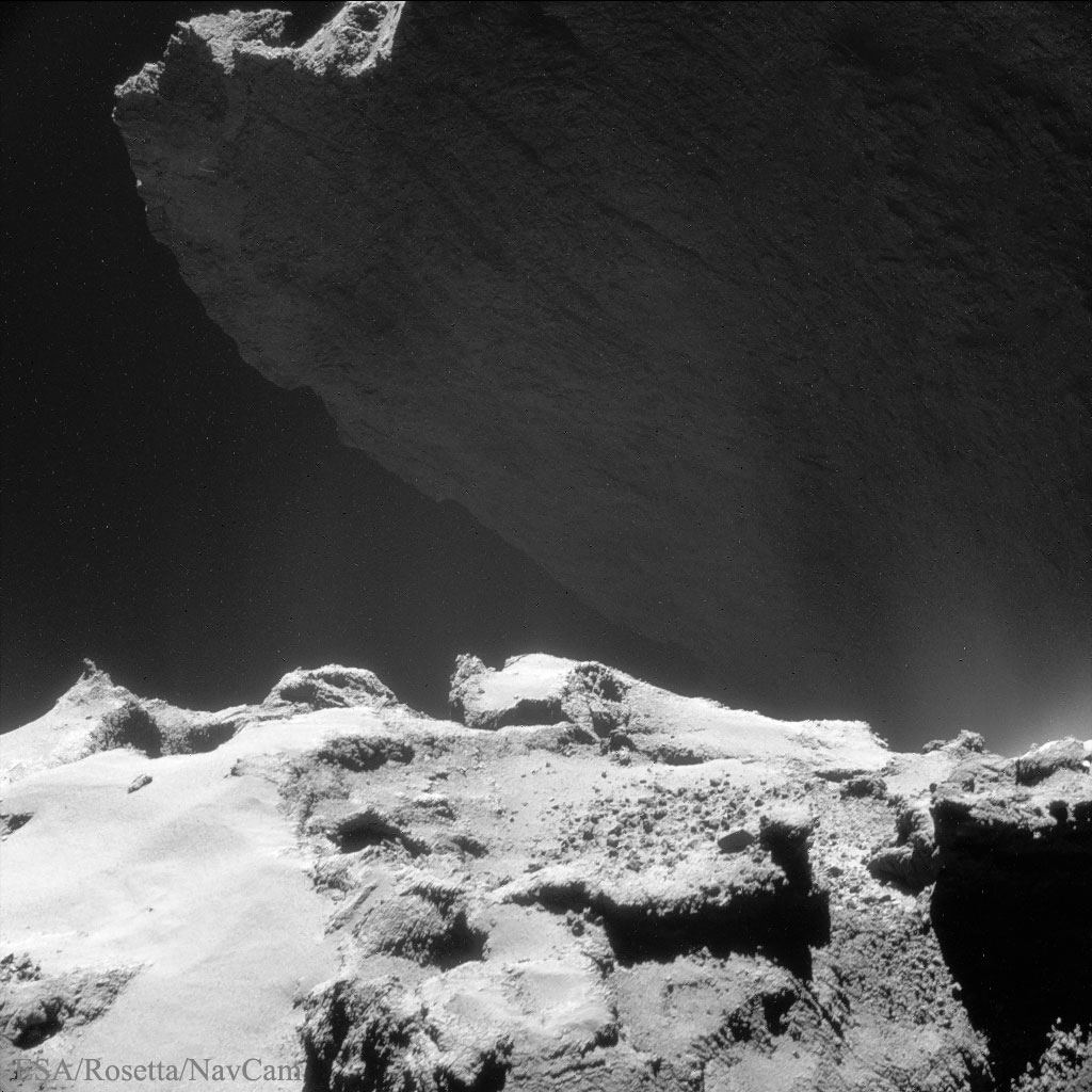 APOD: 2015 May 20 – A Cliff Looming on Comet 67P