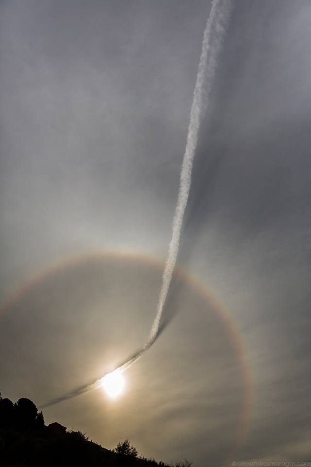 APOD: 2017 April 4 – Plane Contrail and Sun Halo