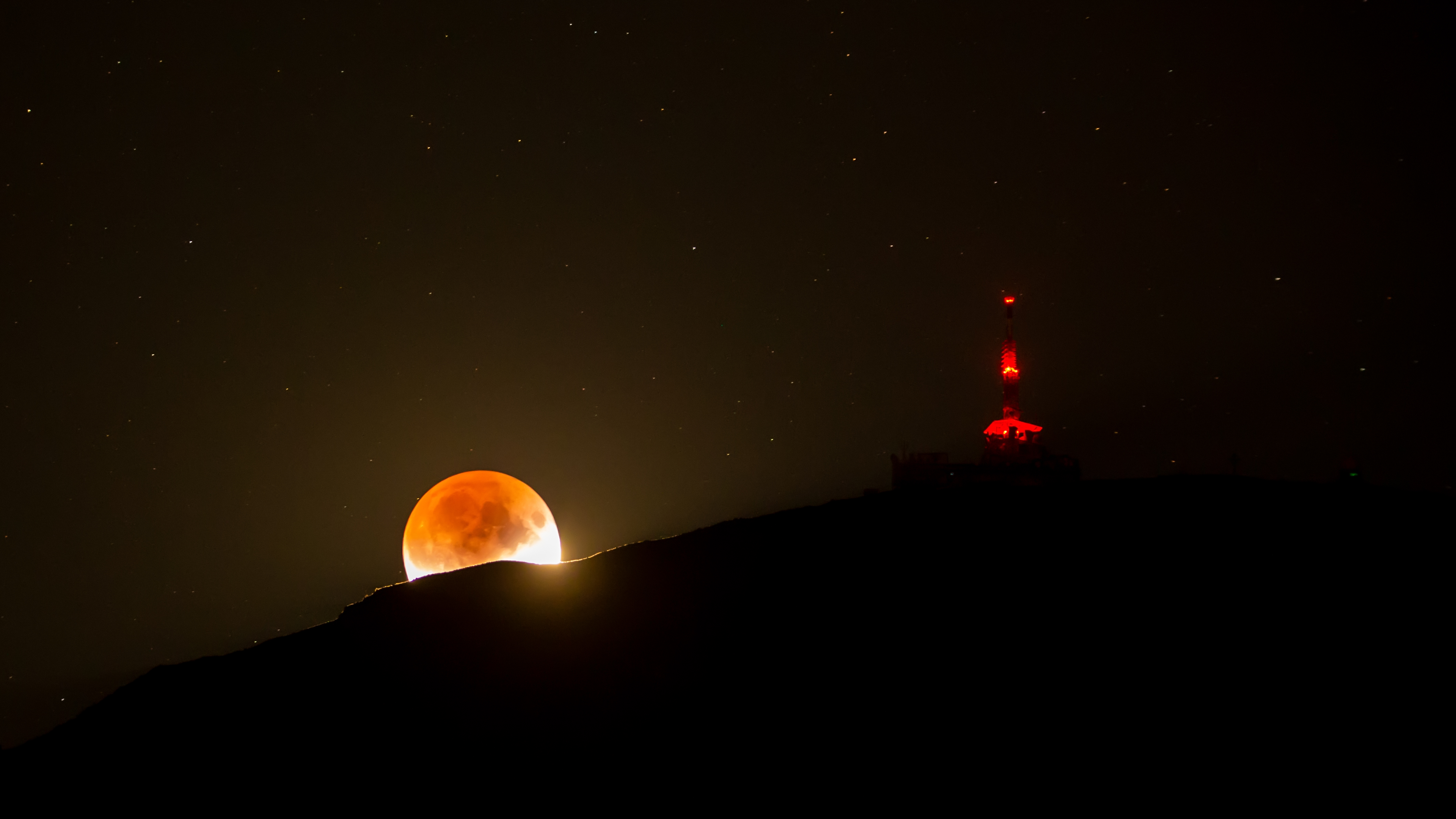 APOD: 2019 July 18 – Shadowed Moon and Mountain