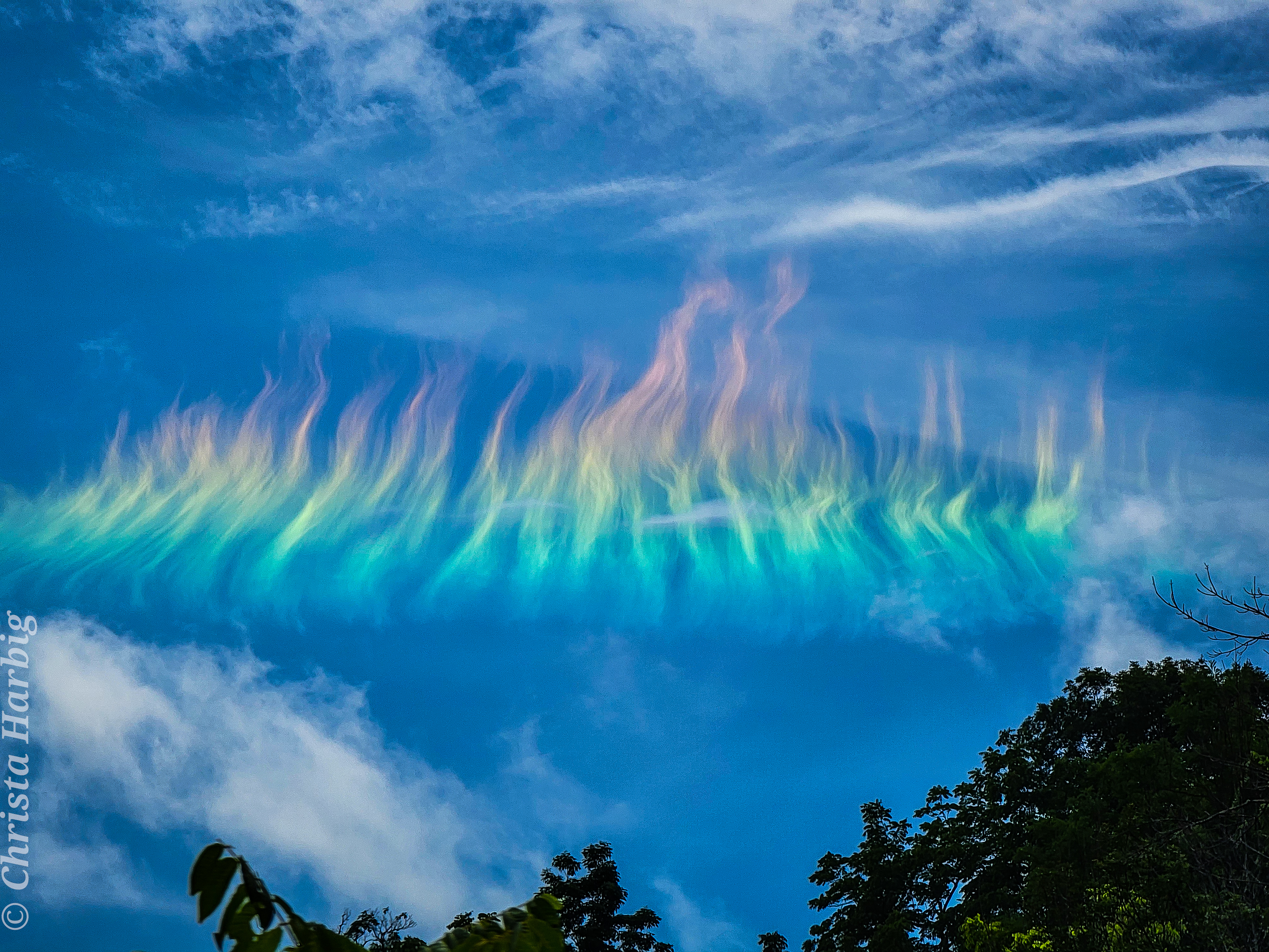 The picture shows a solar circumhorizontal arc -- nicknamed a fire rainbow -- over West Virgina, USA. Please see the explanation for more detailed information.