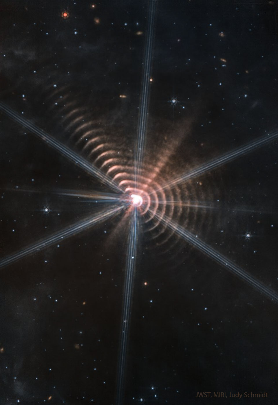 The featured image shows many circular rings surrounding a central star. Other stars are visible in an otherwise dark field. Please see the explanation for more detailed information.