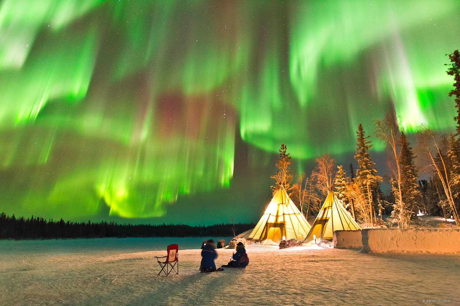 The featured image tipis below a night sky lit up with multiple green auroras. Please see the explanation for more detailed information.