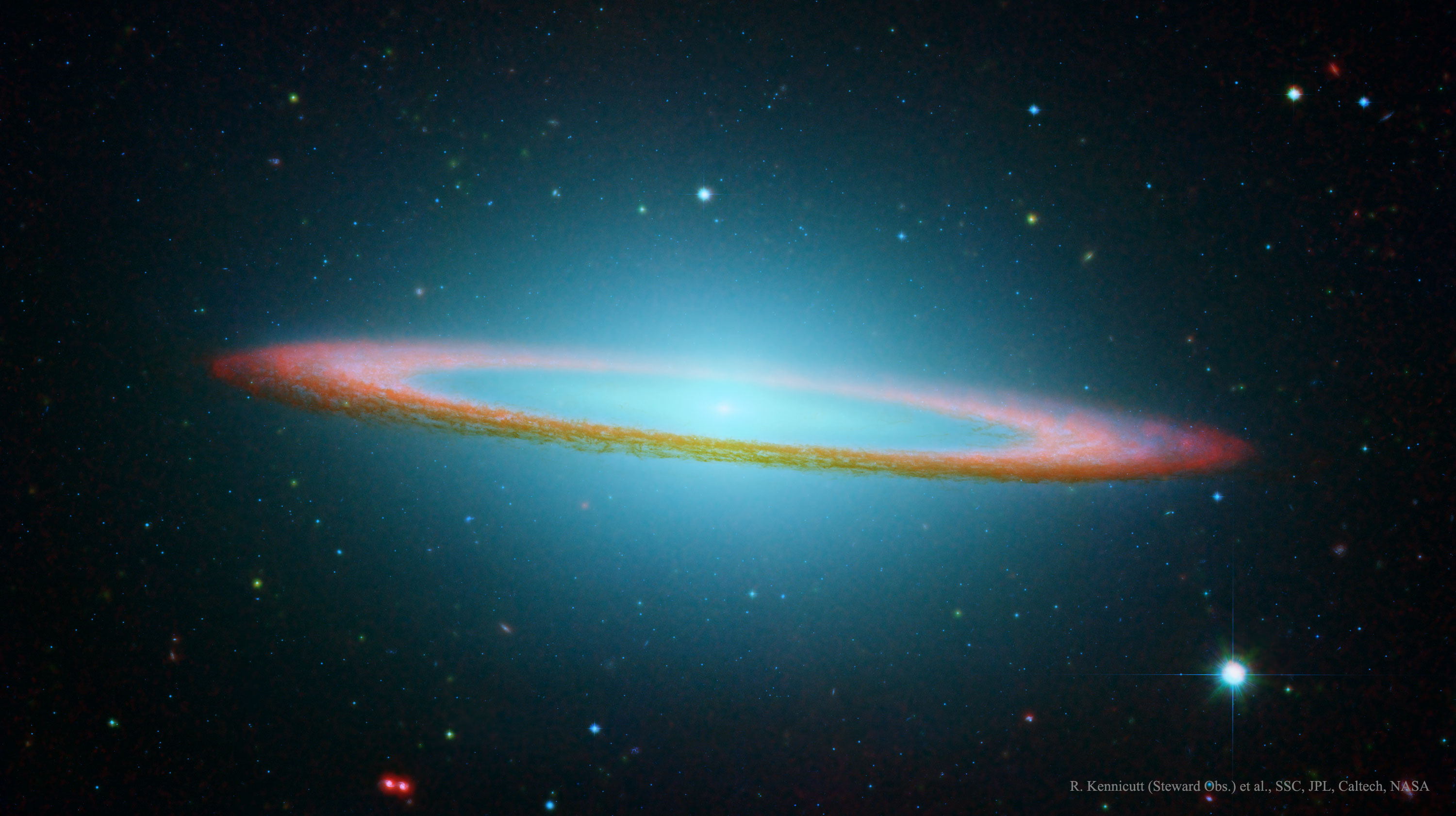 A red-tinged ring of dust is seen nearly on edge. In the ring's center and extending around the frame, blue gas and stars are shown. Please see the explanation for more detailed information.