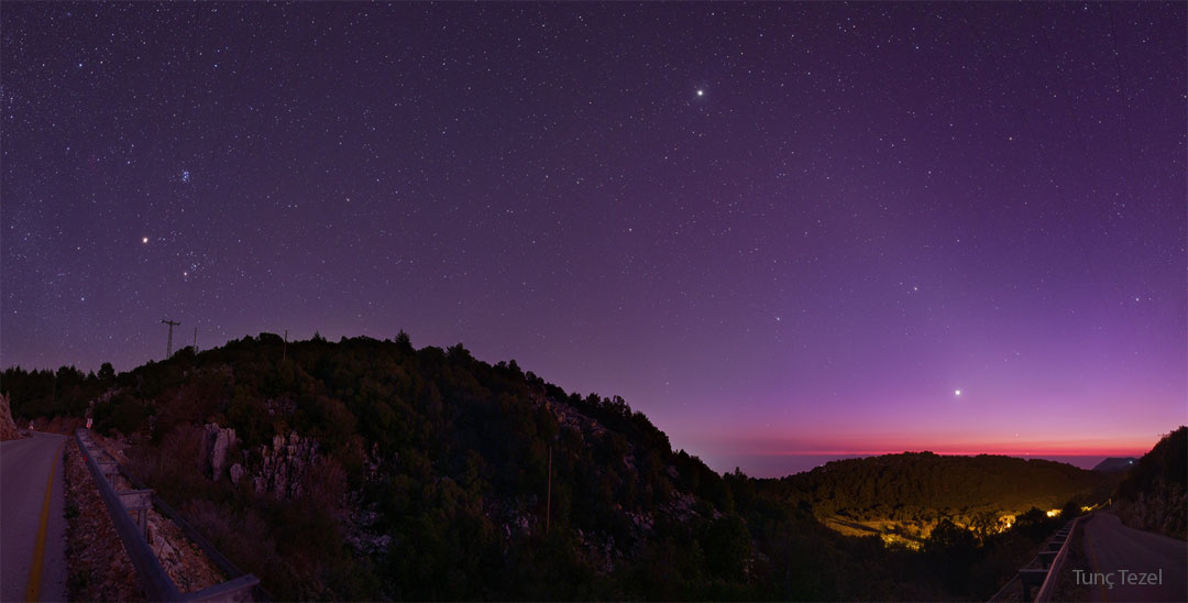 The featured image is a wide-angle image featuring a Turkish village in the foreground and a sky containing off of planets in our Solar System in the background. Please see the explanation for more detailed information.