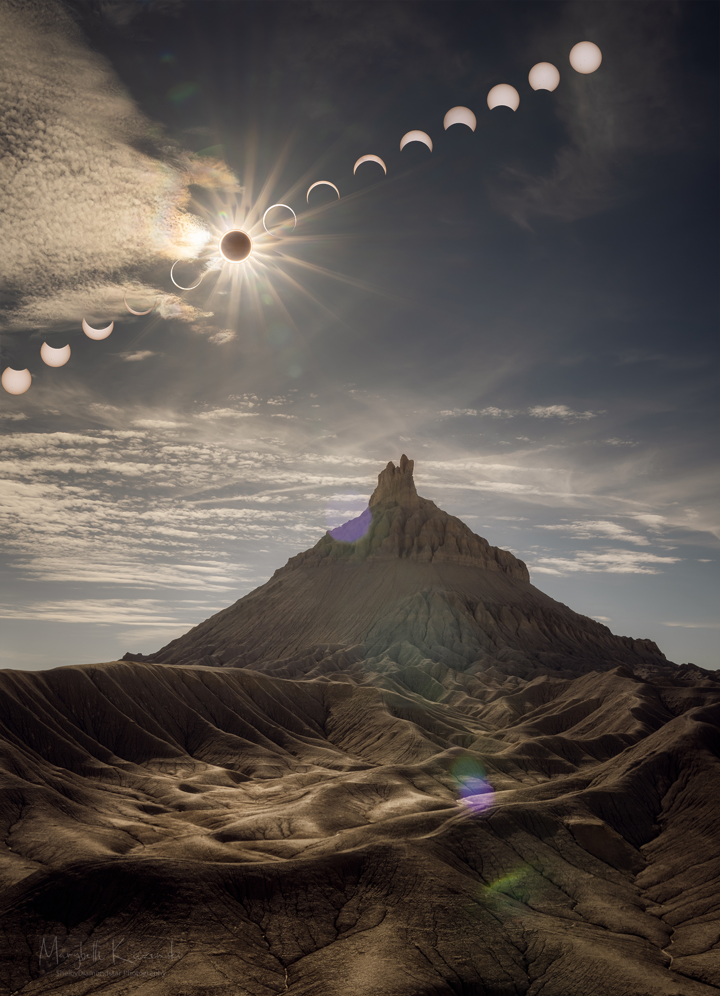 A sequence of Sun and Moon images are shown behind a scenic foreground that features the large Factory Butte. The foreground was taken during the maximum part of the annular eclipse and seems somehow oddly lit. Please see the explanation for more detailed information.