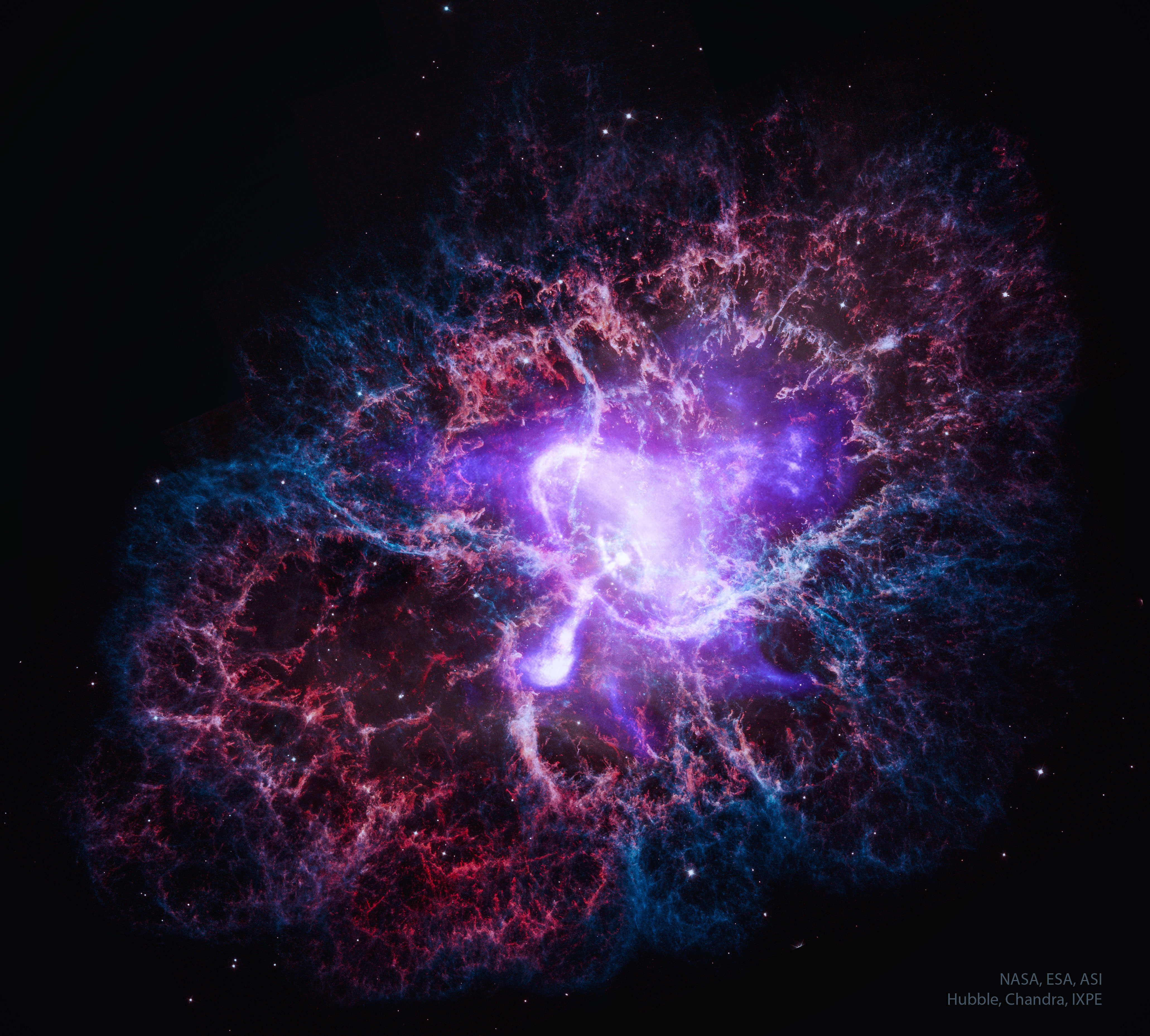 A multi-colored nebula is shown that is the expanding remnant of an exploded star. The central white and purple colors show X-ray light, while the outer red and blue colors show visible light. Please see the explanation for more detailed information.