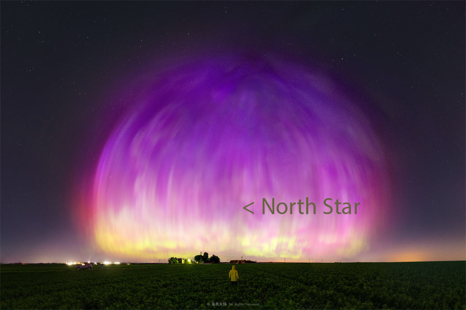A large purple transparent dome appears to cover much of a starry sky. A person stands in a field looking toward the unusual spectacle. Please see the explanation for more detailed information.