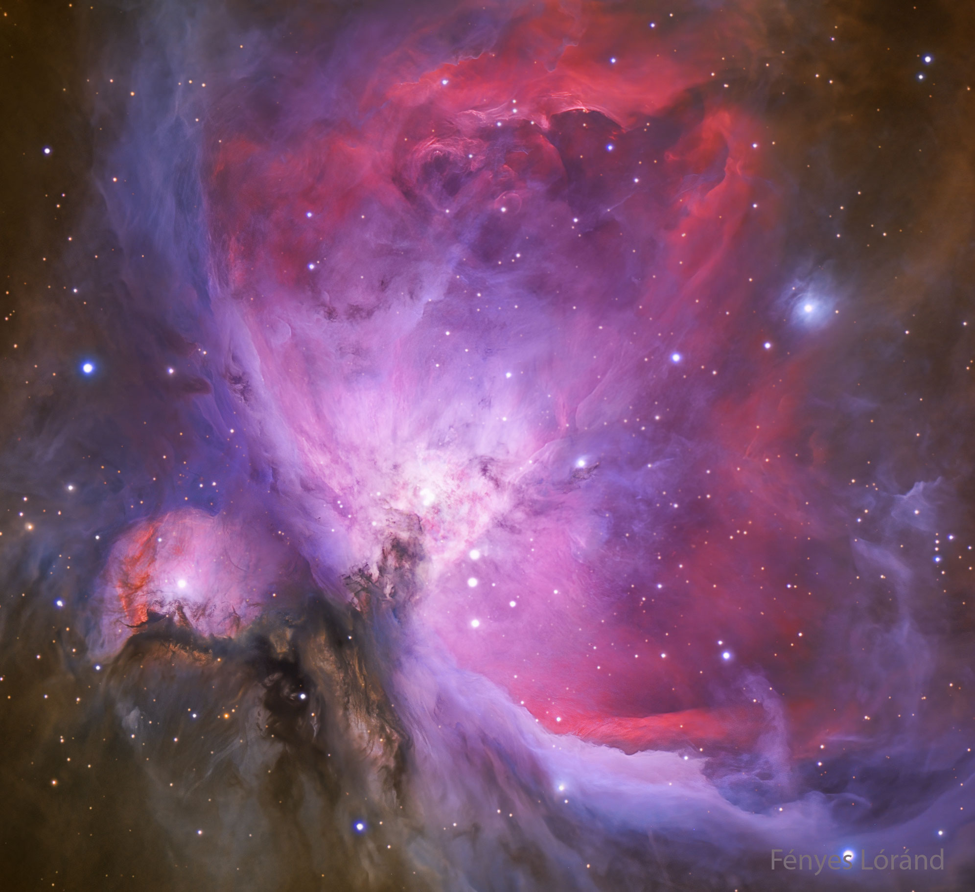 A starfield is shown with a nebula glowing in red, purple, and blue. Dark brown gas is also seen on the lower left. A small cluster of stars appears in the center. Please see the explanation for more detailed information.