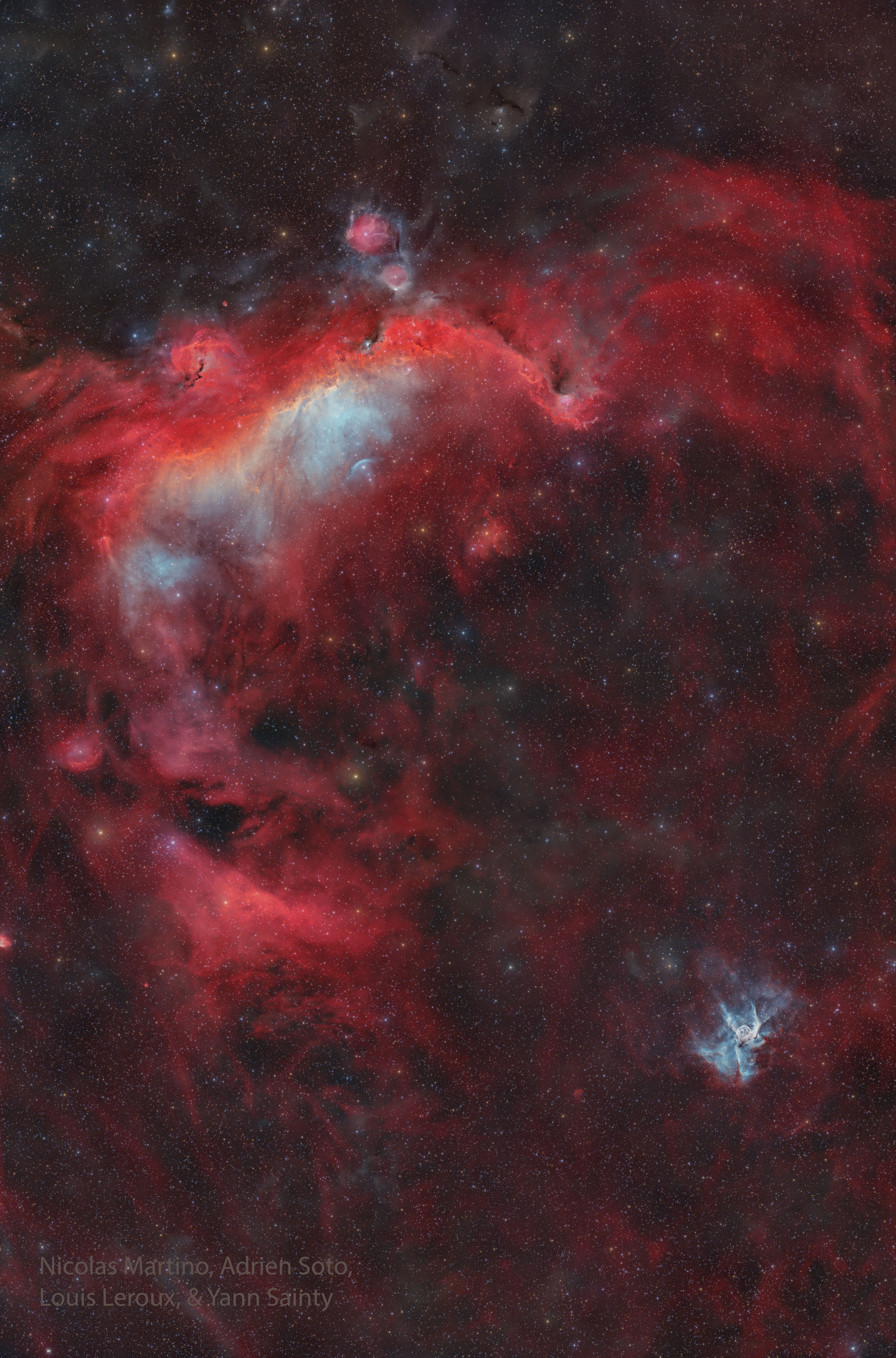 A tall starscape appears to have two bright nebulas. The large one at the top is colored mostly red and is known as the Seagull Nebula. The small one near the bottom right is known as Thor's Helmet. Please see the explanation for more detailed information.