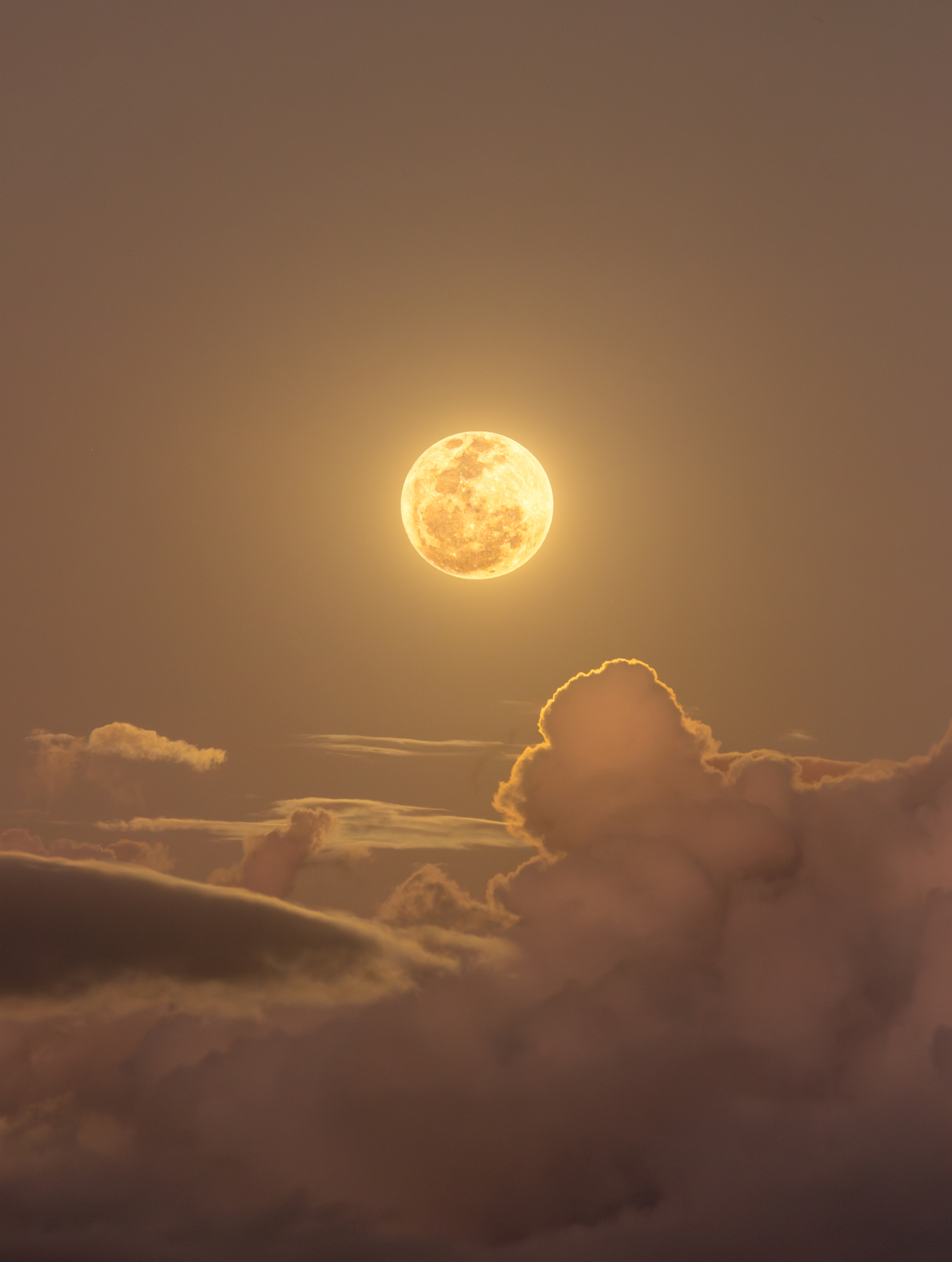 APOD: 2025 July 12 – Clouds and the Golden Moon