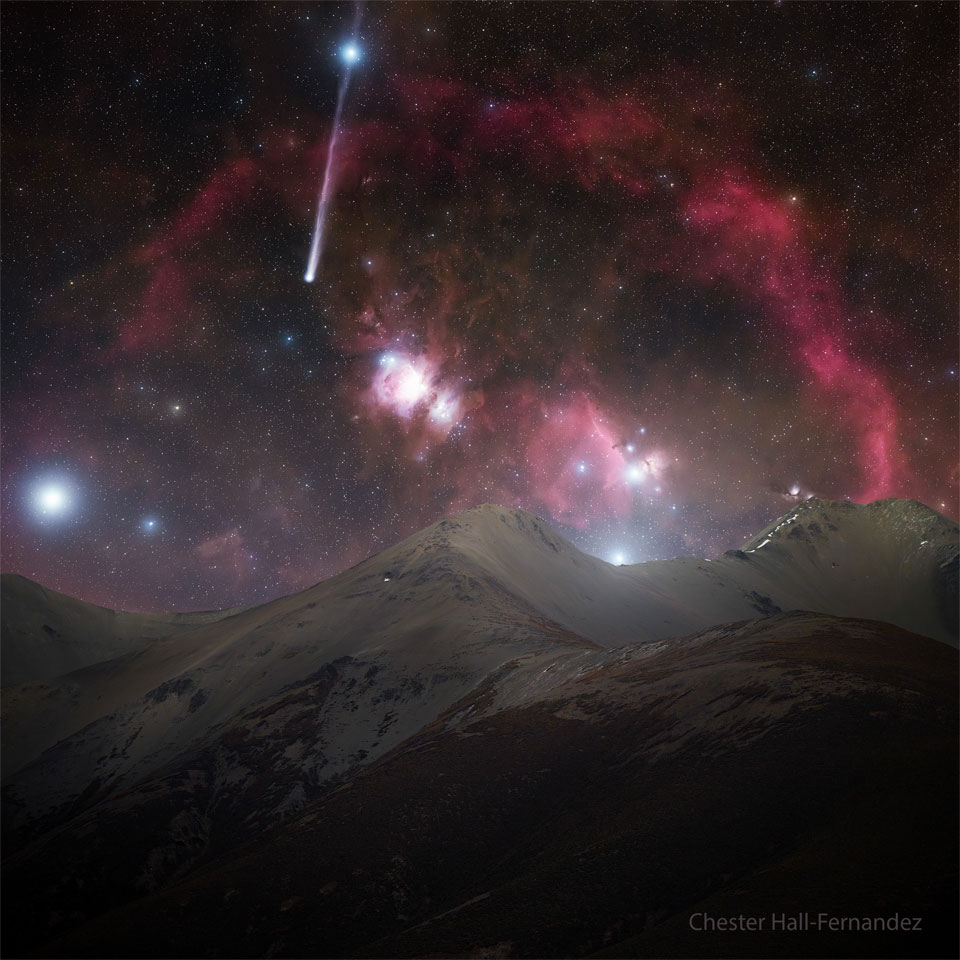 A starfield appears featuring many bright stars, red nebula, and a comet. Snow covered mountains cover the foreground. The comet appears on the upper left with a tail the goes upward and right through a bright star. Please see the explanation for more detailed information.