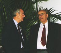Moderator John Bahcall (left) discusses issues with Sidney van den Bergh. Bahcall wonders if at least part of the present disagreement might stem from bias in choosing the list of local galaxies from which Hubble's constant is computed.