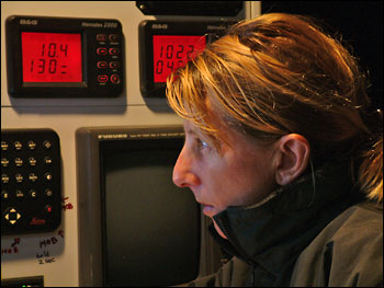 Photograph of Adrienne Cahalan focused on work at her navigation station