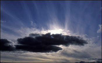 Photograph of transparent cirrus clouds and opaque cumulus clouds