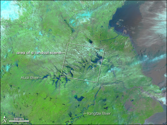 Wide-scale satellite image of floods in China, with area covered by high-resolution sensor for comparison