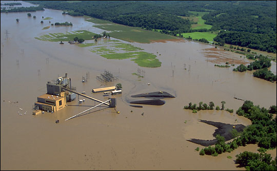 Aerial photograph of a flooded power plant along the Mississippi River, July 1993.