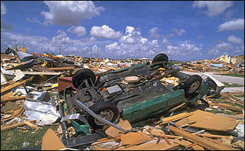 Category 5 damage: flipped car and destroyed buildings
