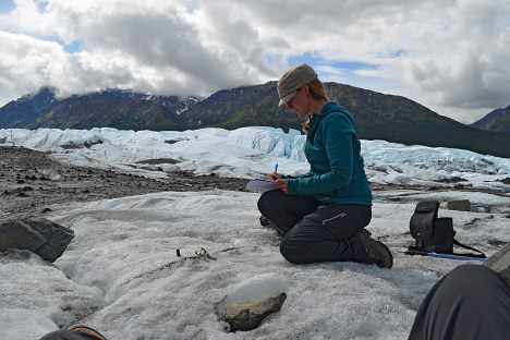 Kimberley Casey working with a themrochron (a small, automated thermometer) on the Matanuska Glacier, Alaska.