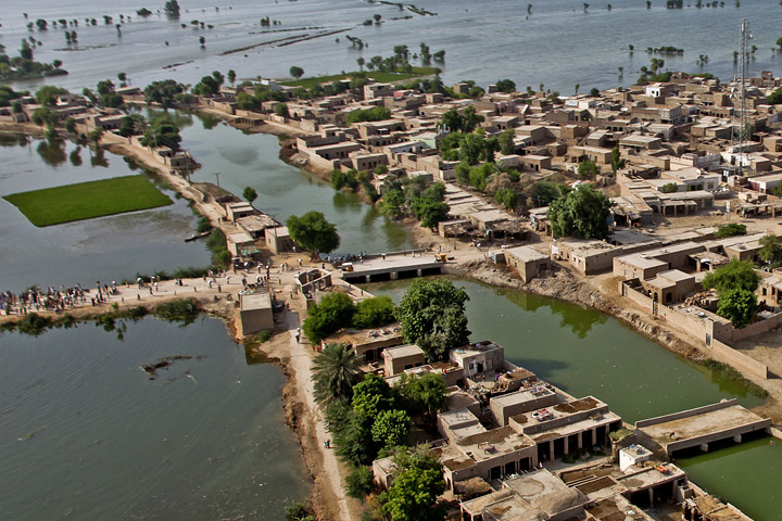 Photograph of flooded fields surrounding a Pakistani village near the Pano Aquil air base.