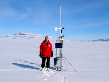 Photograph of Jim Key Standing beside an Isolated Polar Weather Station