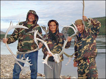 Photograph of Ross Nelson, Guoqing Sun, and Paul Montesano holding reindeer antlers.