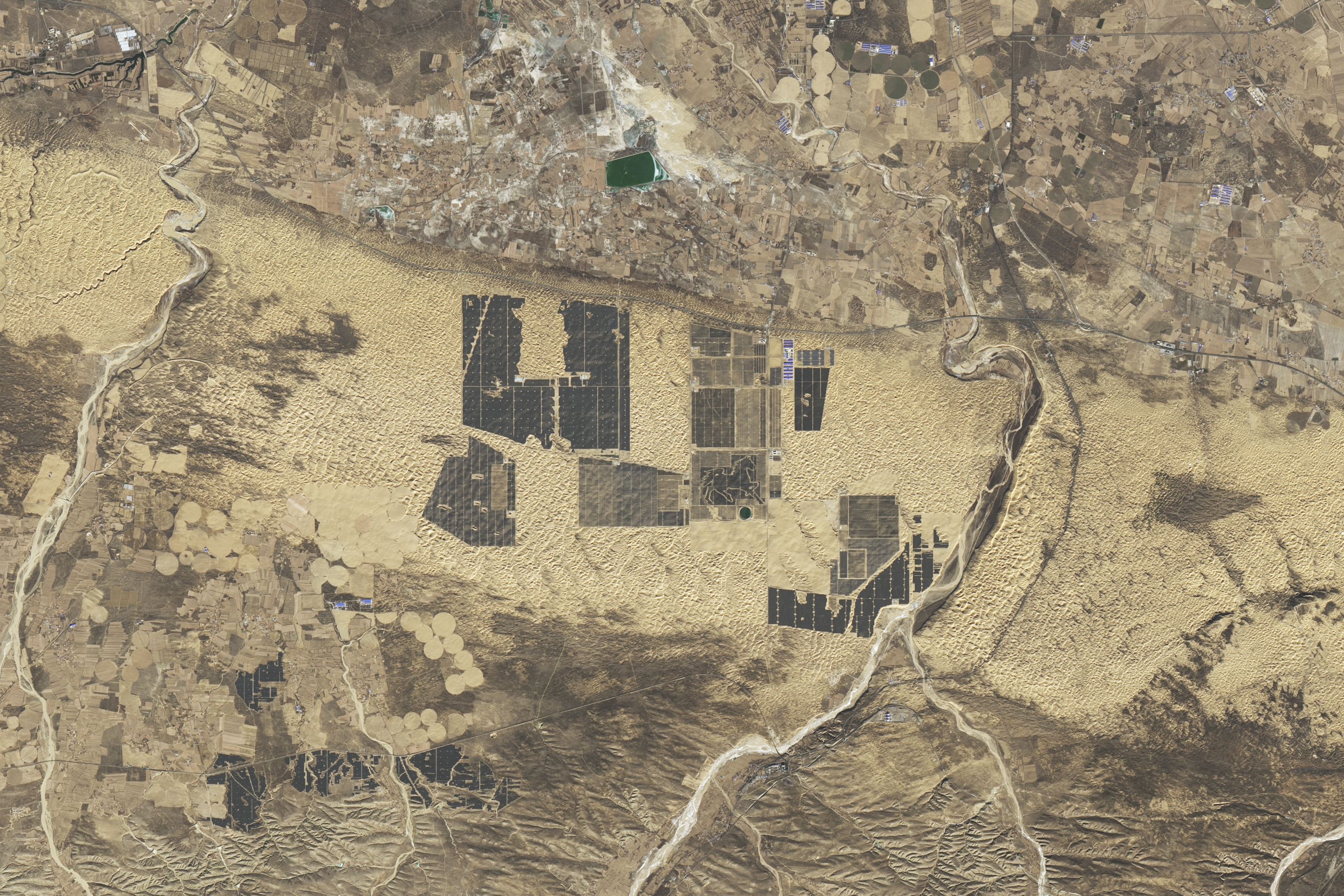 NASA Landsat 8 satellite image of solar panels covering a section of the Kubuqi Desert in Inner Mongolia, China, in December 2024