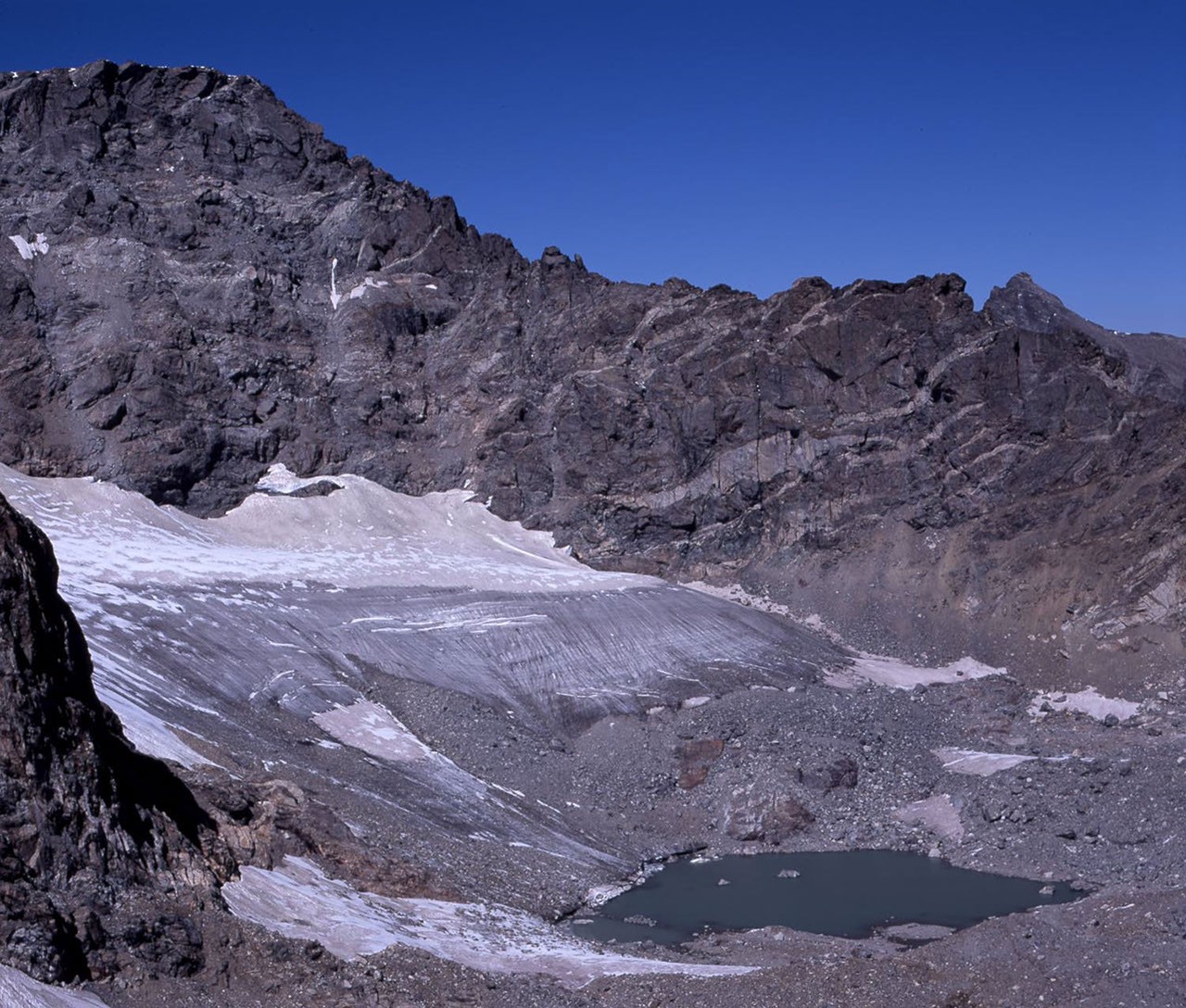 A mountain glacier with rock and snow around it
