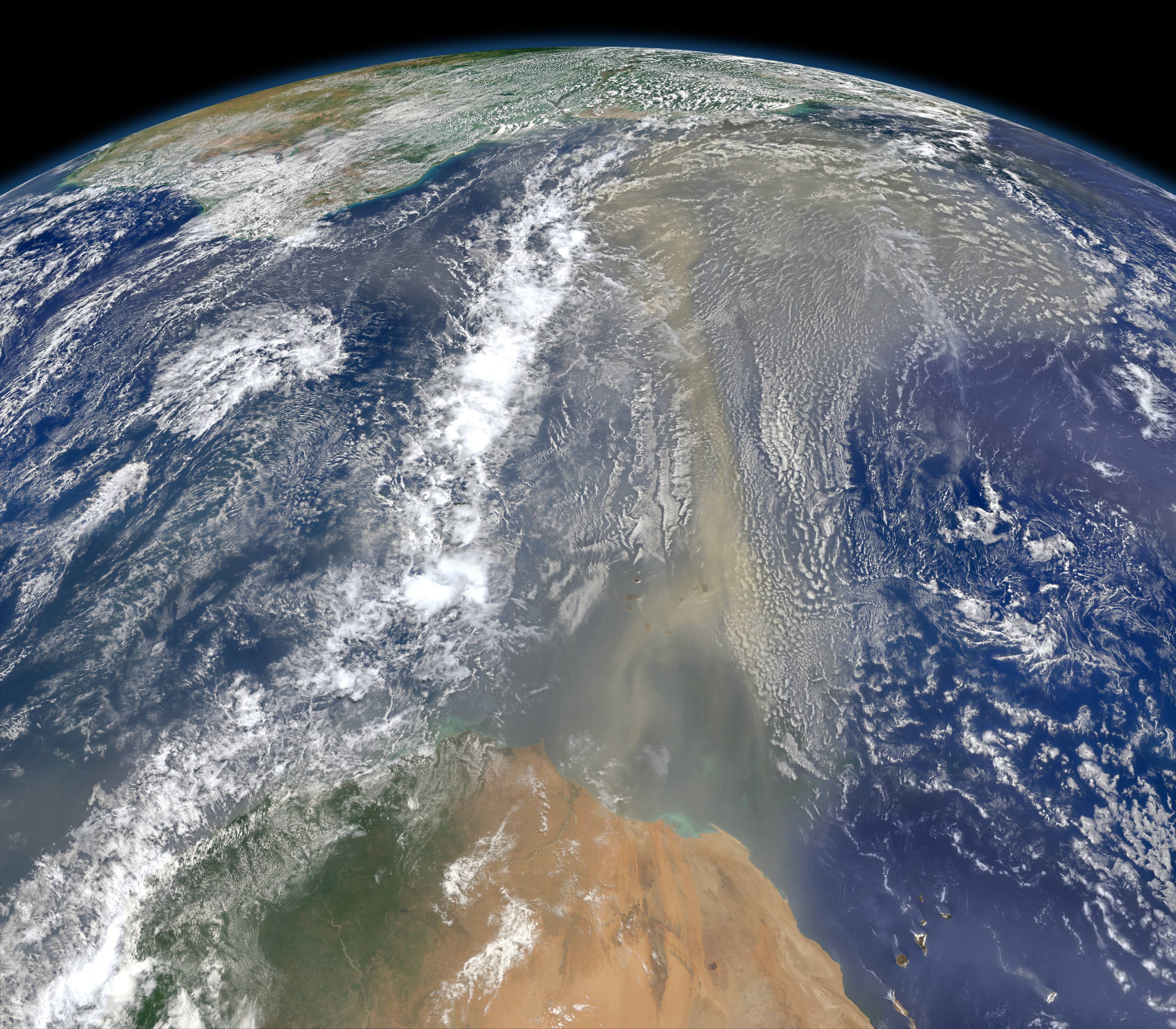 Satellite view of a long river of Saharan dust streaming westward from North Africa across the Atlantic Ocean toward the Americas