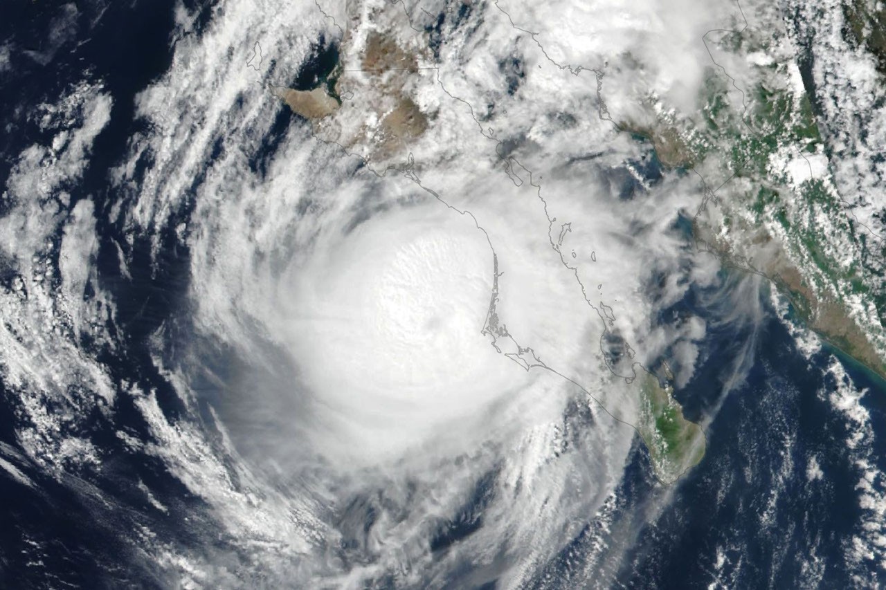 Satellite imagery showing multiple hurricane systems in the Pacific Ocean near Mexico and Hawaii