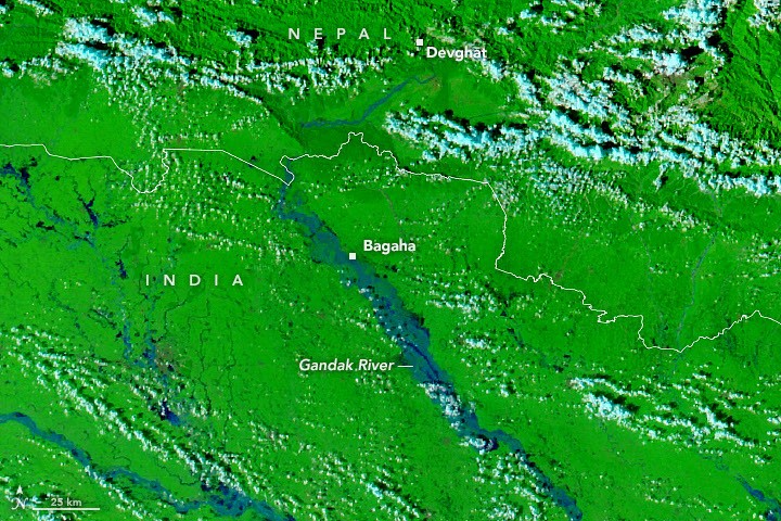 A false-color satellite image shows the same area during the flooding on September 29, 2026. The river appears much wider.