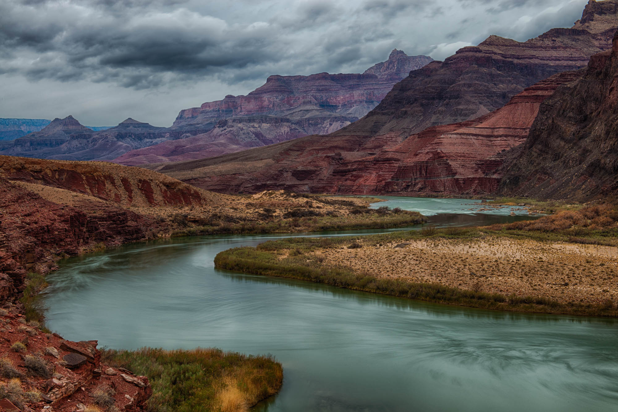 Colorado river curves through the purple and red rocks of the Grand Canyon. Photo by Kendrick Callaway