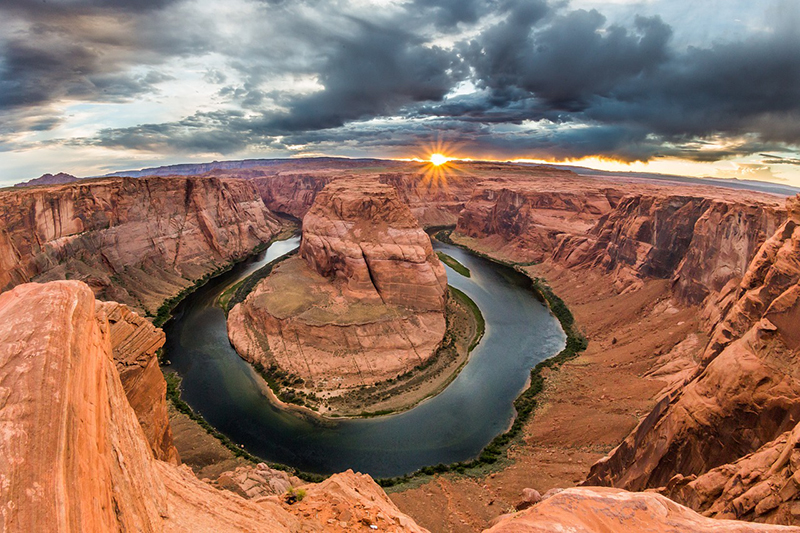 The Colorado River curves through the red rocks of Glen Canyon National Recreation Area in Arizona.