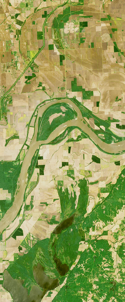 Landsat satellite image showing a river in the form of a capital letter A, surrounded by green land.