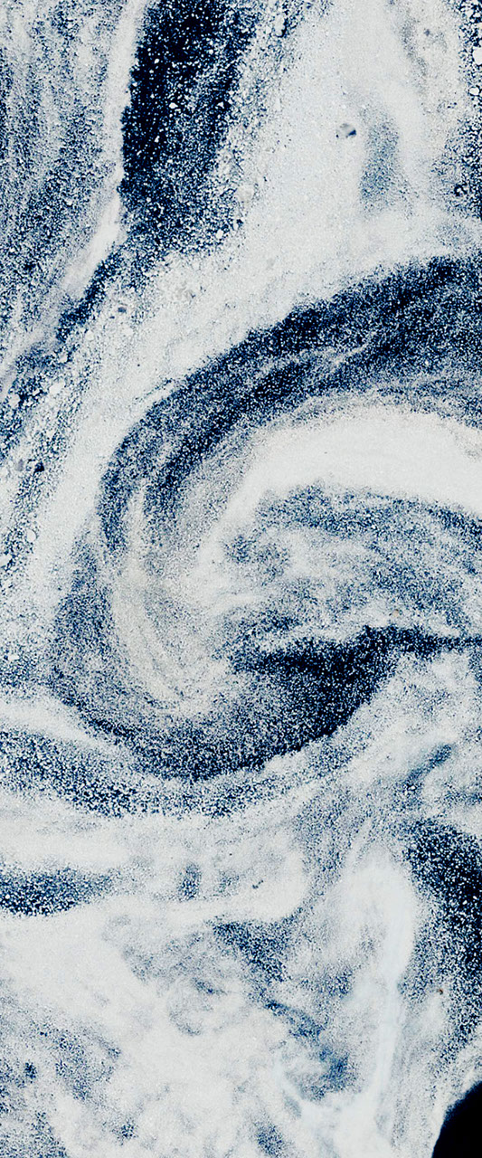 Landsat satellite image of swirling white sea ice and dark ocean water forms the uppercase letter g.
