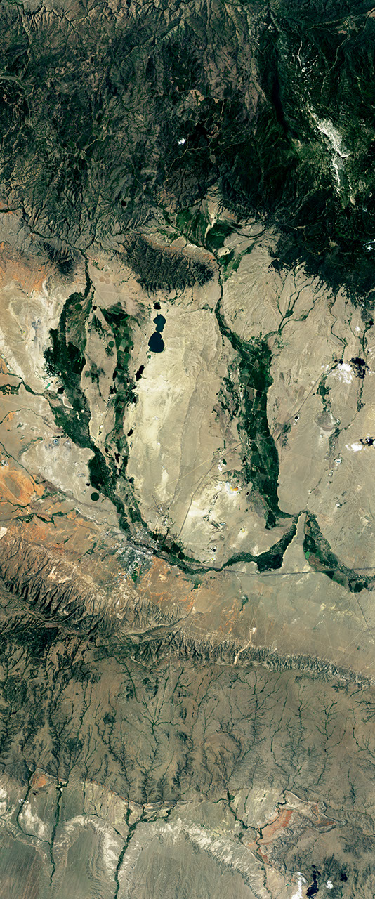 Landsat satellite image showing vegetated areas resembling the lower case letter U.