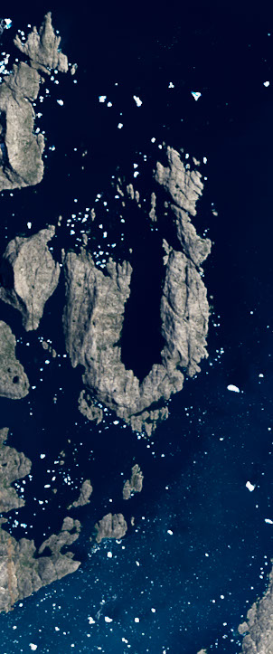 Landsat satellite image showing an island coastline forming the capital letter U surrounded by deep blue water.