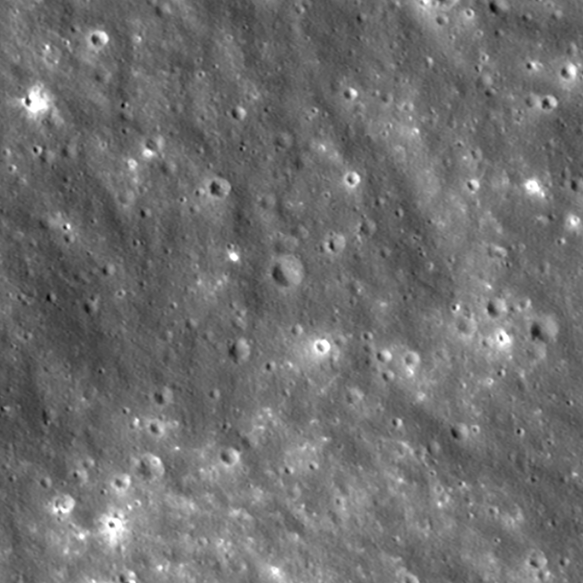 Two-frame animation showing a new crater, with ejecta rays extending outward, appearing on the Moon.