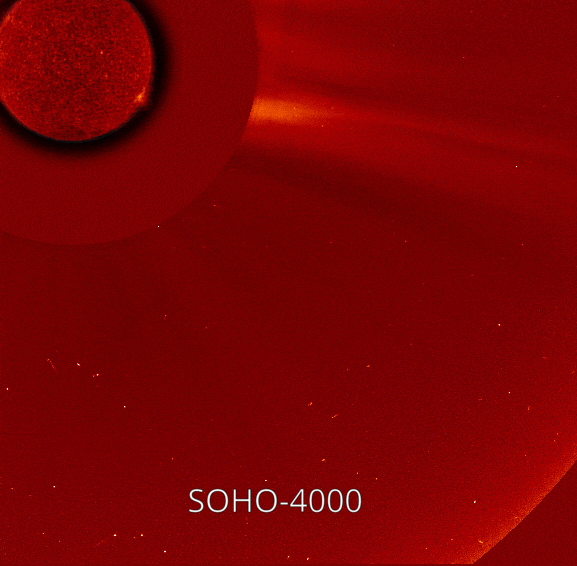 In this animated GIF, two small comets appear one after the other near the bottom of a red-colored background speckled with white stars and move toward the Sun, which appears in red in the upper left. The first comet, which is brighter, is labeled SOHO-3999 and the second is labeled SOHO-4000.