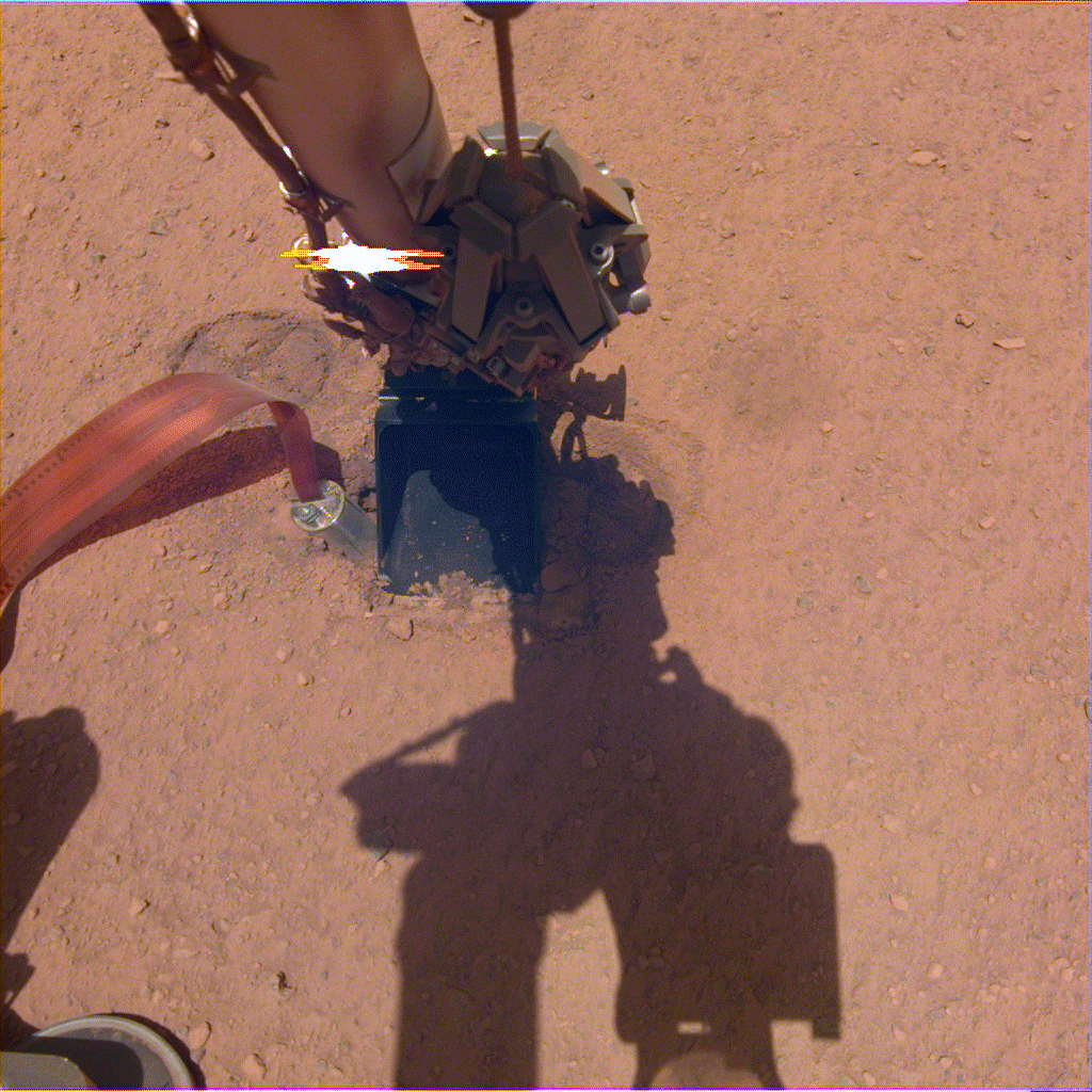 In this image from Oct. 26, 2019 — the 325th Martian day, or sol, of the mission — InSight's heat probe, or "mole," is seen after backing about halfway out of the hole it had burrowed.