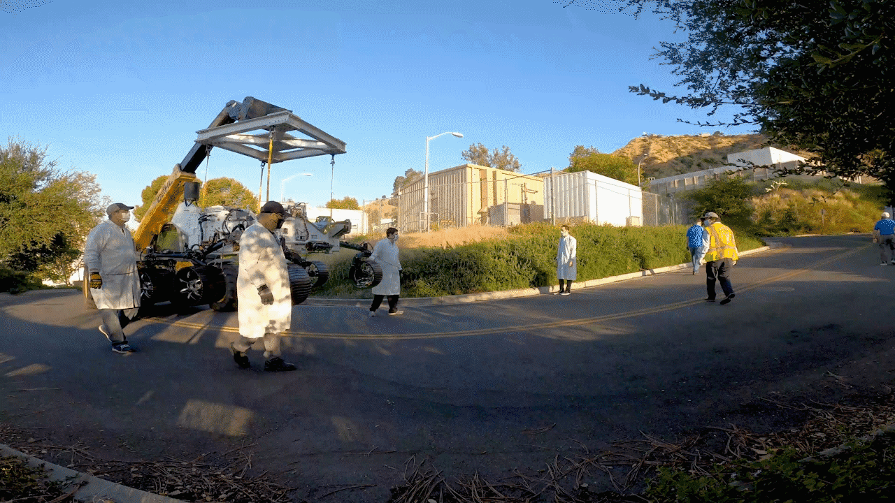 Technicians move an engineering version of Perseverance rover